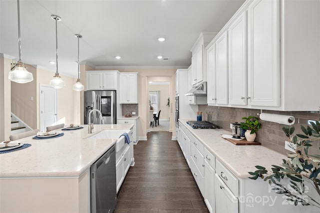 kitchen with decorative light fixtures, decorative backsplash, white cabinets, and stainless steel appliances