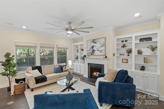 living room featuring ceiling fan, wood-type flooring, and crown molding