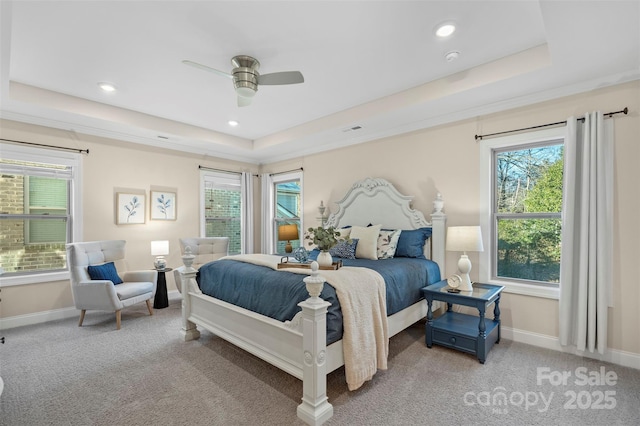 bedroom with ceiling fan, a raised ceiling, and carpet floors