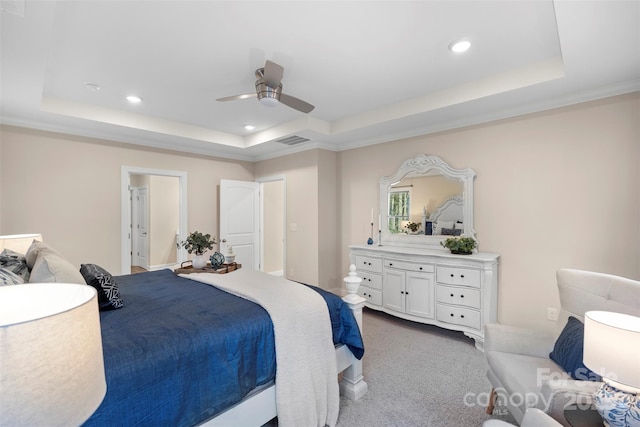 carpeted bedroom featuring ceiling fan, crown molding, and a tray ceiling