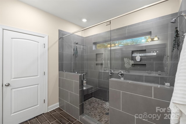 bathroom with a shower with door