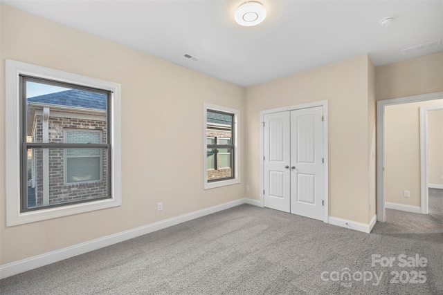 unfurnished bedroom featuring a closet and carpet floors