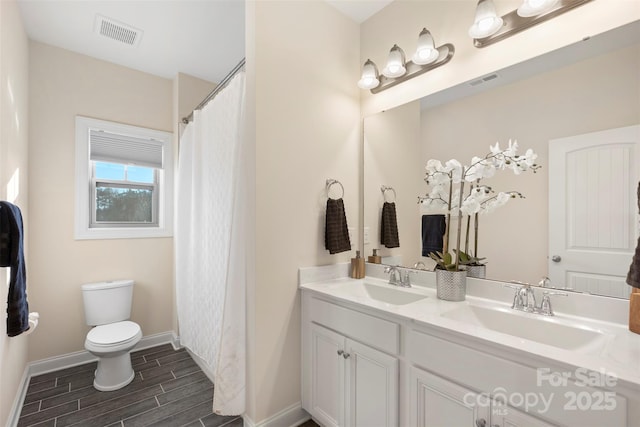 bathroom featuring toilet and vanity