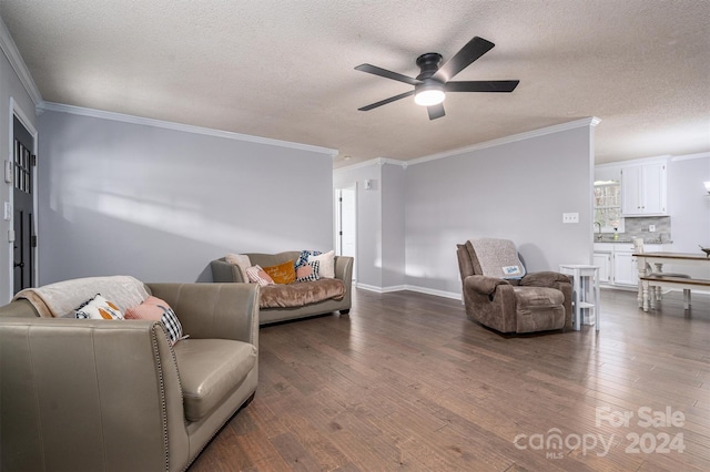 living room with a textured ceiling, hardwood / wood-style floors, and crown molding