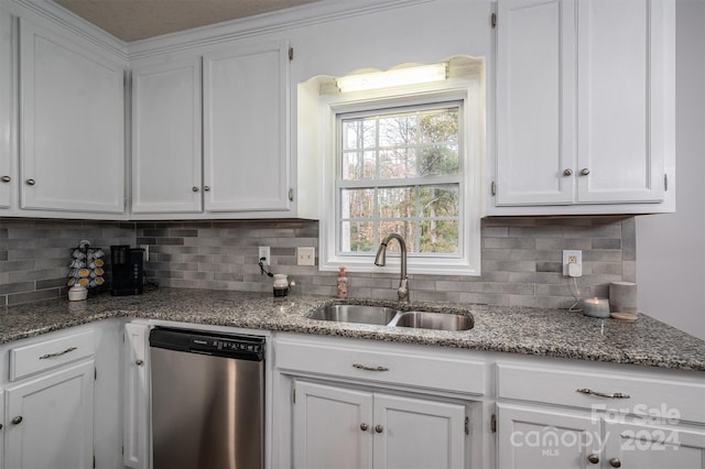 kitchen featuring dishwasher, sink, backsplash, and white cabinets