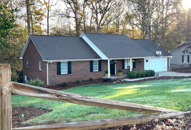 ranch-style home with a garage and a front yard