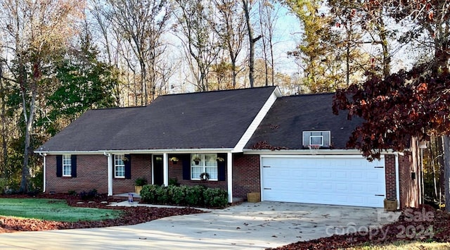 view of front of home with a garage and a front lawn