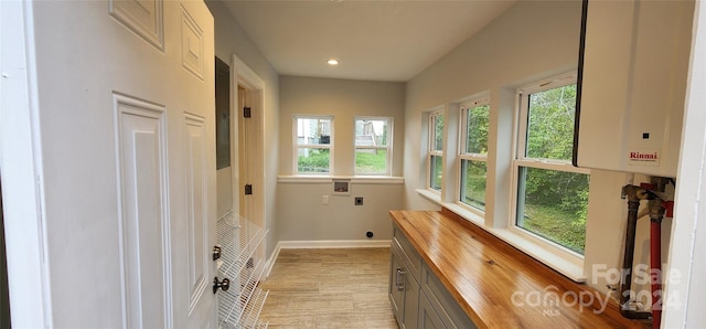 interior space with a healthy amount of sunlight and tankless water heater