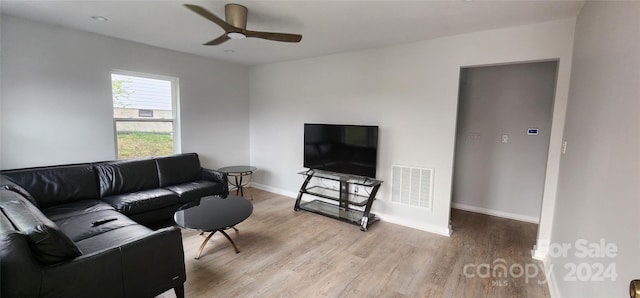 living room featuring light wood-type flooring and ceiling fan