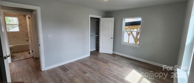 unfurnished bedroom with a closet and wood-type flooring