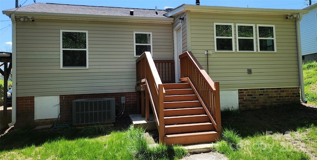 back of house with central AC unit