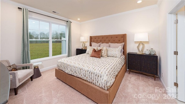 bedroom with ornamental molding and light colored carpet