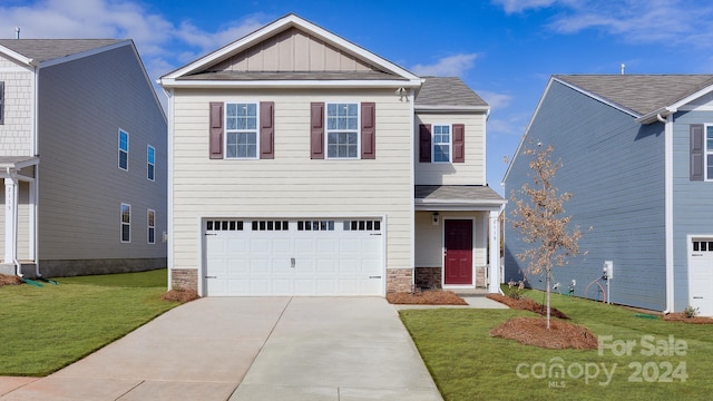 view of front of property with a garage and a front lawn