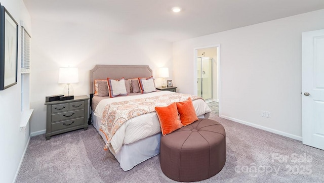 bedroom featuring light carpet and ensuite bath