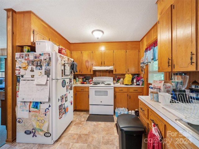 kitchen with white appliances and a textured ceiling