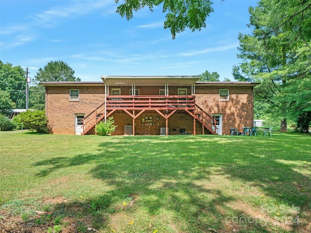 back of property with a yard and a deck