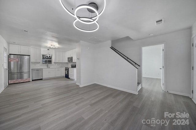 unfurnished living room with light hardwood / wood-style floors