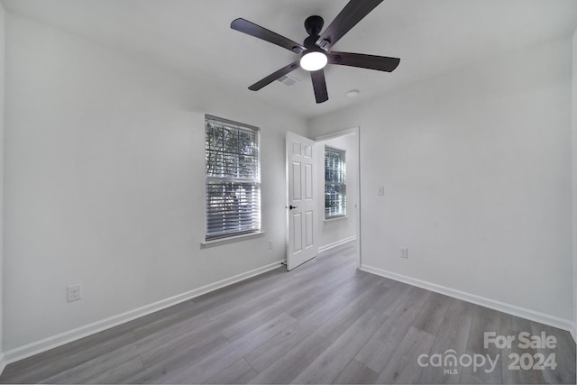 empty room with light hardwood / wood-style floors and ceiling fan