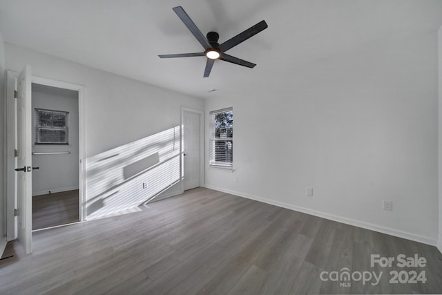 empty room with ceiling fan and wood-type flooring