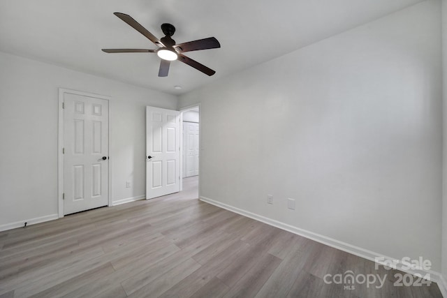 unfurnished bedroom featuring light hardwood / wood-style flooring and ceiling fan