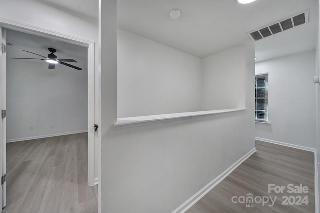 corridor with wood-type flooring