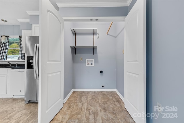 laundry area with hookup for a washing machine, sink, and crown molding