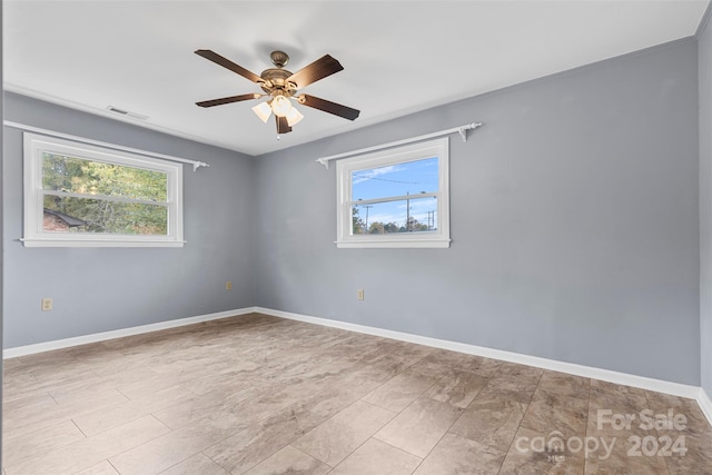 spare room featuring a wealth of natural light and ceiling fan