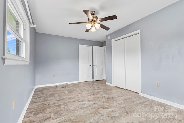 unfurnished bedroom featuring ceiling fan