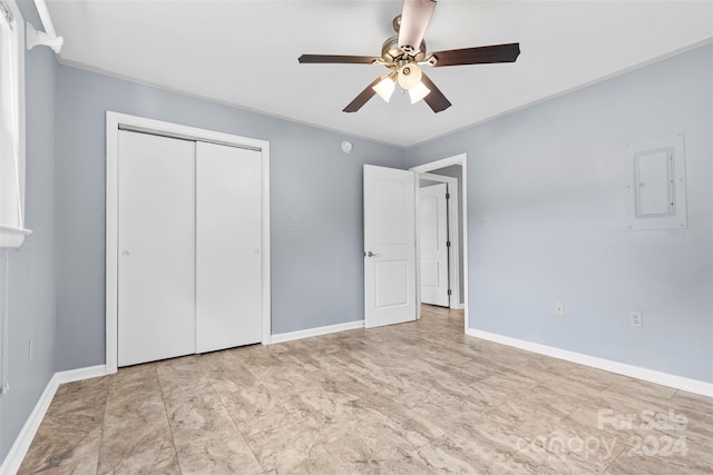 unfurnished bedroom with electric panel, a closet, and ceiling fan