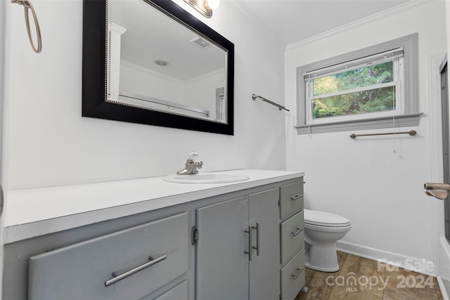 bathroom featuring vanity, crown molding, and toilet