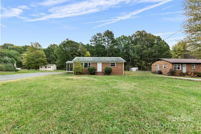 ranch-style house with a front lawn