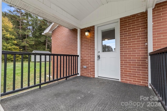 doorway to property featuring a lawn