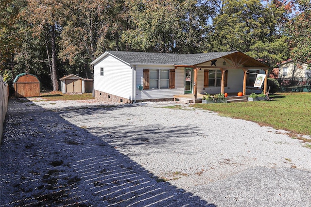 view of front of home featuring a shed and a porch