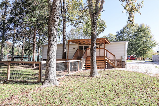 exterior space with a front yard and a wooden deck