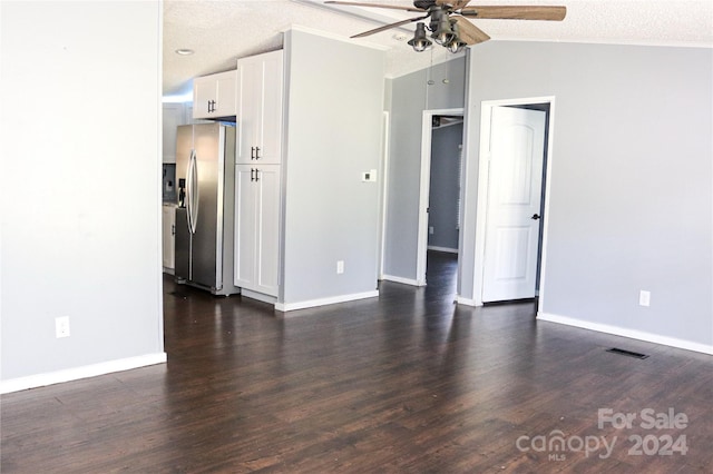 unfurnished room with dark wood-type flooring, vaulted ceiling, a textured ceiling, and ceiling fan