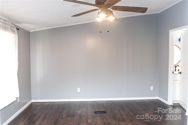 empty room with dark wood-type flooring, ceiling fan, ornamental molding, and a textured ceiling