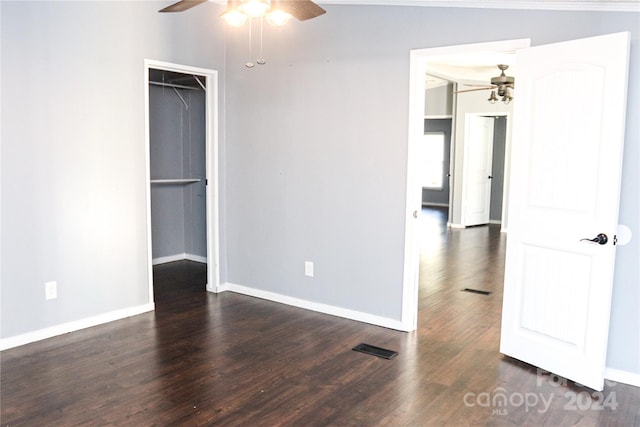 empty room with lofted ceiling, dark wood-type flooring, and ceiling fan