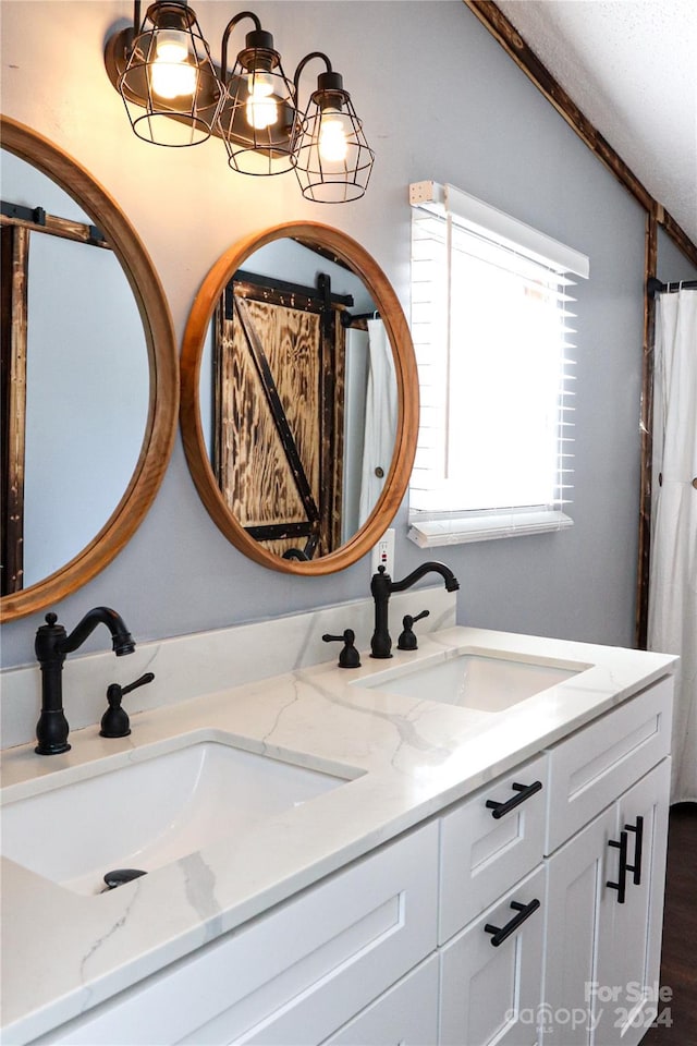 bathroom featuring vanity, an inviting chandelier, and wood-type flooring