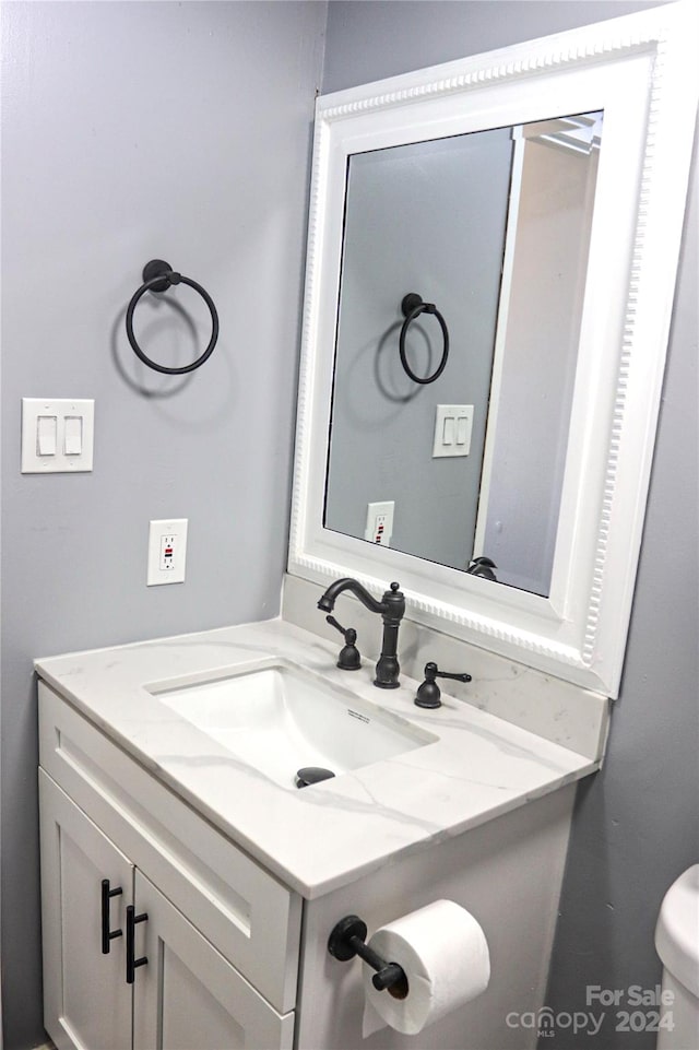 bathroom featuring toilet and vanity