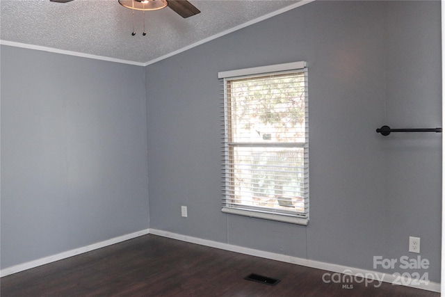 unfurnished room featuring lofted ceiling, ceiling fan, a textured ceiling, dark wood-type flooring, and crown molding