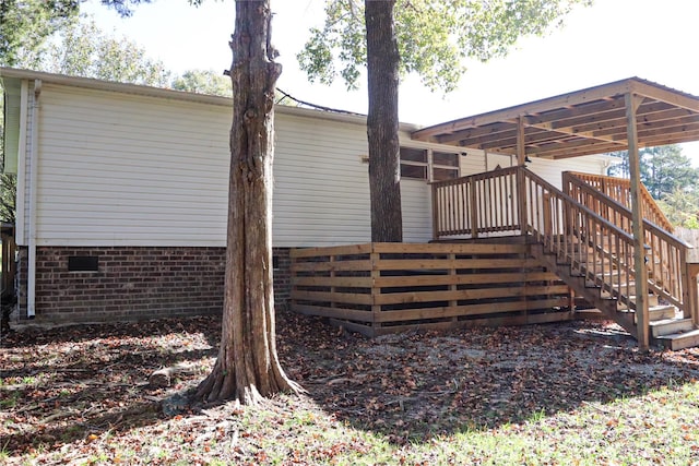 view of side of home featuring a wooden deck