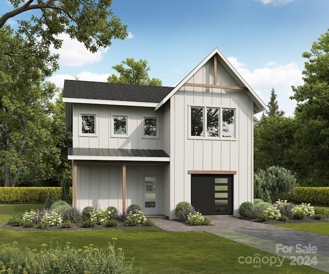 modern farmhouse with a front yard and a garage