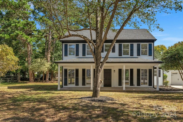 view of front of home with a front yard and a garage