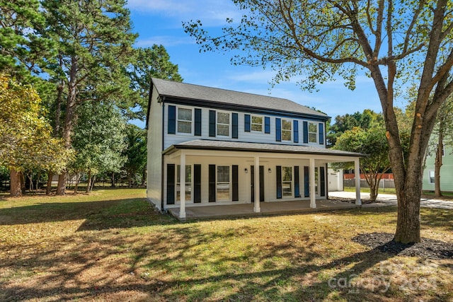 view of front of house featuring a front yard and a patio area