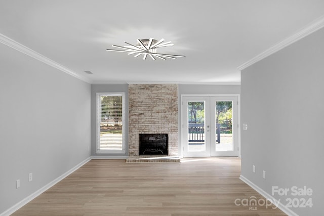 unfurnished living room with ornamental molding, light hardwood / wood-style flooring, and plenty of natural light