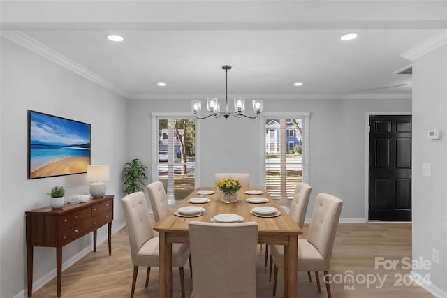 dining space with ornamental molding, a chandelier, and light wood-type flooring