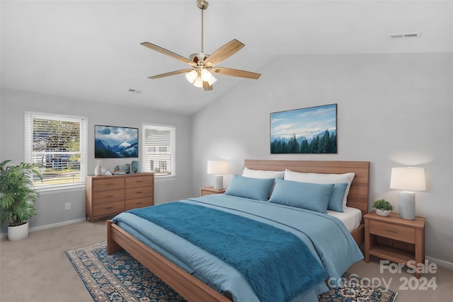 carpeted bedroom with ceiling fan and vaulted ceiling