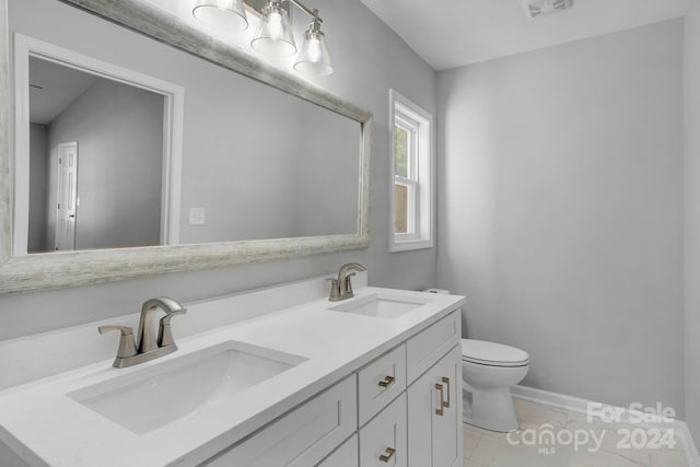 bathroom featuring vanity, toilet, and tile patterned flooring