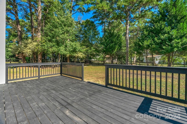 wooden terrace with a lawn