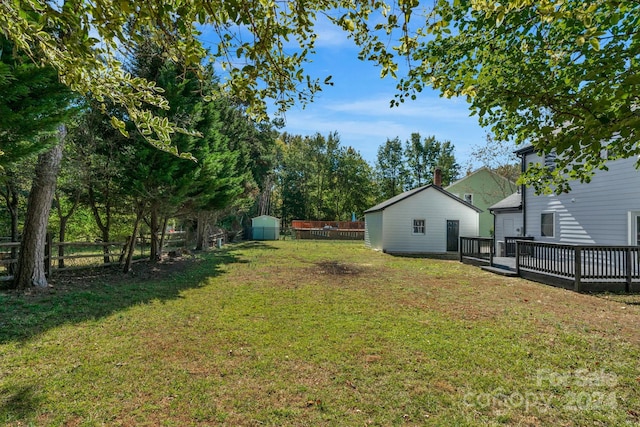 view of yard featuring a shed and a deck